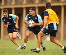 Waratahs flanker Phil Waugh runs with the ball during training