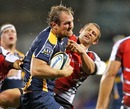 The Brumbies' Rocky Elsom fends off the Lions defence