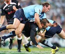 The Sharks' Stefan Terblanche is tackled by the Waratahs
