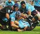 The Waratahs' Tom Carter crosses for a try